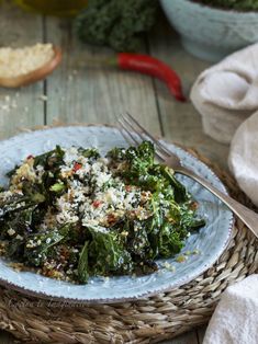 a white plate topped with greens and rice