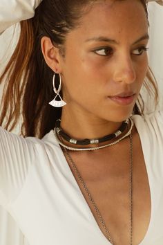 This Beautifully handcrafted choker necklace consists of 9 Tuareg Inspired motif beads. The Amari sits beautifully on it’s own, or layered to create a classy ethnic look for any occasion. You will want to wear this piece each and everyday. Includes extension chain for desired length . The Amari choker is a smaller beaded version to the Zaire choker ,if you would prefer this custom made with a different length please send me info via Dm . DETAILS :* Made from strong cotton rope string and High Quality white brass * Length of Black string with white Brass beads 33 cm* Length of extension chain 13 cm* Total length 46 cm* Width approx 1 cm* Weight 42 grams Jewelry Care : ✼ Jewelry will oxidise over time with everyday wear and exposure. Use a polishing cloth to restore shine . Avoid water and l Adjustable Oxidized Choker Jewelry, Elegant Dangle Choker For Festival, Adjustable Boho Collar Jewelry As Gift, Fair Trade Multi-strand Jewelry As Gift, Adjustable Dangling Beads Choker, Adjustable Silver Bead Choker, Handmade Bohemian Sterling Silver Choker, Handmade Sterling Silver Bohemian Choker, Festival Choker With Silver Beads