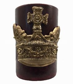 a gold crown on top of a wooden stand