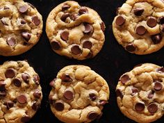 six chocolate chip cookies on a baking sheet