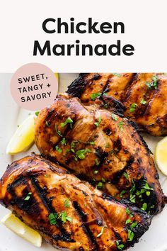 grilled chicken marinade on a white plate with lemon wedges and parsley