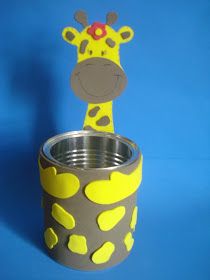 a cup with a giraffe cut out of it sitting next to a blue background