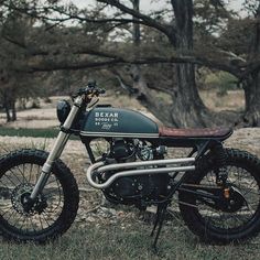 a motorcycle parked on top of a grass covered field