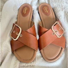 Clark’s Camel Leather New Never Worn Comfortable And Classy Size 9 Vacation Summer Classic Gold Buckle Leather Summer Vacation Brunch Brown Faux Leather Sandals For Vacation, Leather Mules With Buckle Closure For Beach, Brown Faux Leather Sandals For Beach, Beach Brown Faux Leather Sandals, Brown Faux Leather Flat Sandals, Brown Flat Faux Leather Sandals, Beach Sandals With Buckle Closure In Faux Leather, Brown Mules With Buckle Closure For Vacation, Leather Sandals With Buckle Closure For Day Out