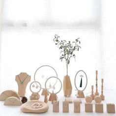 a group of wooden objects sitting on top of a white floor next to a window