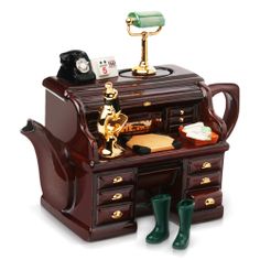 an antique desk with green rubber boots on the bottom and gold trimmings around it