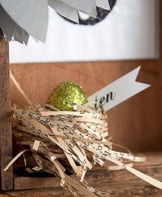 a close up of a clock on a wooden table with tape and scissors next to it