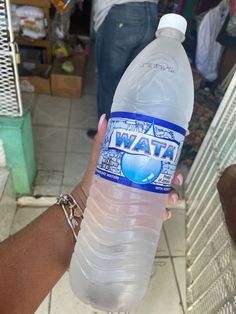 a person holding a bottle of water in their hand