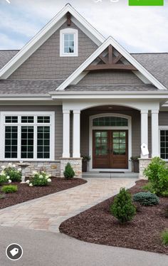 a house with landscaping around the front door