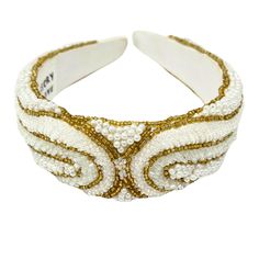 Slip on the Love Unstoppable Headband for a touch of effortless glamour. This wide headband is adorned with gold and pearl beading for an elegant yet comfortable fit. Perfect for adding a little extra sparkle to your look. Handmade Length 5 in Structured Band Satin Fabric Seed Bead Detailing Elegant Gold Hair Accessories With Matching Headband, Elegant Adjustable Cream Headband, Elegant Adjustable Embellished Headband, Adjustable Gold Beaded Headpieces, Elegant Gold Beaded Headpieces, Elegant Adjustable Gold Headband, Thick Pearl Headband, Elegant Rhinestone Headband, Elegant Adjustable Rhinestone Headband