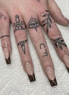 a person with some tattoos on their fingers