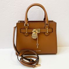 New With Tag Michael Kors Hamilton Small Satchel Shoulder Crossbody Bag Pebbled Leather Luggage 100% Authentic Retail: $368.00 Plus Tax ***Please See The Measurement For The Size*** No Dust Bag Michael Kors Logo At Front Zip Top Closure Gold Toned Hardware Mk Key & Lock On Front Custom Mk Fabric Lining 1 Slip-In Pockets 1 Zipper Pocket 10" (L) X 8"(H) X 4"(D) Strap: 4", 18"- 24" Very Clean, Smoke-Free And Pet-Free Environment. Leather Shopping Bags With Lock, Travel Tote Bag With Lock, Brown Travel Bag With Turn-lock Closure, Travel Shoulder Bag With Lock And Double Handle, Michael Kors Travel Satchel With Gold-tone Hardware, Brown Shoulder Bag With Lock For Travel, Travel Satchel Bag With Lock, Cognac Satchel Bag With Turn-lock Closure, Luxury Michael Kors Bag With Turn-lock Closure