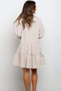 The EMES SHOP dress is detailed with a classic gingham print. Features a collar. contrast button down detail. 3/4 length sleeves. tiered dress. straight cut. and above knee length. Pair it with a clutch and heels for a fabulous look this season.MATERIAL:100%Soft Poly MEASUREMENTS:Dress Length is 36"-39"in Small | Bust & Waist: 38"-40"in Medium | Bust & Waist: 40"-42"in Large | Bust & Waist: 42"-44"in X Large | Bust & Waist: 44"-46"in Long Sleeve Plaid Dress With Ruffle Hem, Chic Plaid Dress With Ruffles For Spring, Chic Gingham Plaid Dress For Fall, Spring Long Sleeve Mini Dress With Houndstooth Pattern, Long Sleeve Gingham Dress For Work, Chic Plaid Shirt Dress For Spring, Spring Brunch Plaid Dress, Spring Plaid Long Sleeve Dress For Work, Feminine Plaid Spring Dress