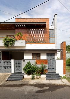 an apartment building with planters on the balconies and stairs leading up to it