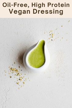 a white bowl filled with green liquid on top of a table