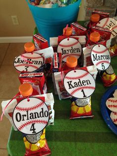 a table topped with lots of candy bags and baseball themed candies on top of it