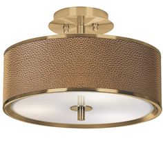 a flush light fixture with a gold finish