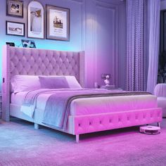 a bedroom with purple lighting and a pink bed