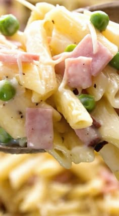 a spoon full of pasta with ham and peas