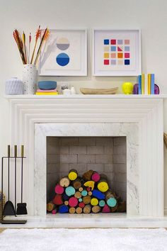 a white fireplace with art on the mantle