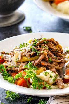 a white plate topped with meat and veggies