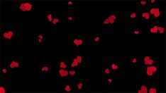 red hearts floating in the air on a black background