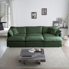 a living room with a green couch and coffee table