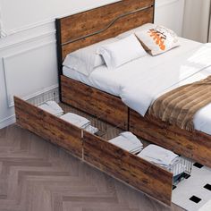 a bed with two drawers underneath it in a room next to a window and wooden floor