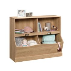 a book shelf with two open compartments and stuffed animals on it's sides, sitting against a white background