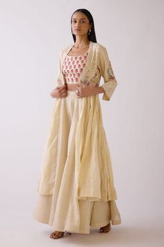 Dull beige long jacket with side pleats and placement floral motif work paired with banarasi lehenga. This set comes with embellished cropped blouse.
Components: 3
Fabric: Chanderi silk
Neckline: Round
Sleeve Length: Jacket: Three Quarter
Color: Beige
Embroidered
Front open jacket
Side pleats
Woven motif lehenga
Chevron pattern jacket - Aza Fashions Spring Traditional Choli For Reception, Traditional Spring Choli For Reception, Spring Designer Lehenga With Chikankari Embroidery, Spring Anarkali Lehenga With Chikankari Embroidery, Spring Zari Work Lehenga In Traditional Drape, Spring Lehenga With Dupatta In Traditional Drape, Spring Resham Embroidery Lehenga In Traditional Drape, Spring Wedding Anarkali Set With Cutdana, Designer Beige Chanderi Lehenga