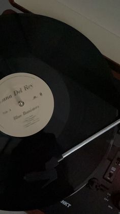 an old record player sitting on top of a wooden table