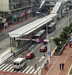 buses and cars at an intersection in the city