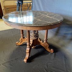 Beautiful dark gray Carrara marble French dining table or center accent table with lovely veining on the top of the exquisitely beveled round table top. Intricate turned walnut base allow this versatile table to be either a dining table comfortably seating 4 - 6, or the table can also serve as a beautiful entry table that will add elegance to any home. #6501 apron 26.75 h Marble Top Table Antique, French Dining Table, Small Round Dining Table, Round Wood Table, French Dining Tables, Table With Marble Top, Table With Marble, Circle Table, Round Table Top