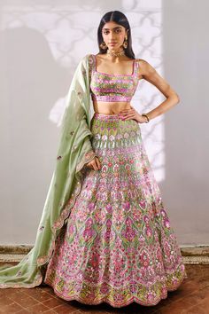 Sage green silk organza lehenga with tonal pink flowers, mirror and foil applique embroidery. Paired with a embroidered blouse and cutwork dupatta.
Component: 3
Pattern: Embroidered
Type Of Work: Floral
Neckline: Square
Sleeve Type: Sleeveless
Fabric: Silk Organza
Color: Green
Other Details: 
Embroidered blouse
Floral pattern
Cutwork dupatta
Occasion: Bride,Destination Wedding - Aza Fashions Green Silk Lehenga With Pallu, Green Lehenga With Pallu In Silk, Green Silk Lehenga With Pallu Detail, Green Organza Lehenga For Reception, Festive Green Lehenga With Sheer Dupatta, Green Anarkali Silk Choli, Green Dola Silk Sharara For Reception, Green Chanderi Set For Reception, Green Silk Sets For Reception