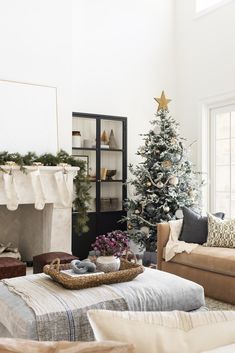 a living room filled with furniture and a christmas tree