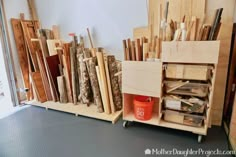 several different types of wood on display in a room with metal flooring and white walls