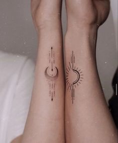 two people with matching tattoos on their arms, both have sun and moon tattoo designs