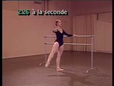 a woman in a black leotard standing next to a metal rail with the words 26 la seconde on it