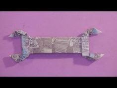 an origami dachshund made out of money on a purple background