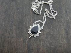 A Black Onyx pendant sits in the centre of your neck on a delicate fine silver chain. The Black Onyx is decorated with dotted details shaping a star frame around the stone. Perfect for layering or worn alone for a simple but stylish look. Black Onyx Protection * Release * Calm Known as a protective stone that can bring more focus & balance to your life. Size Guide: Adjustable size Length: 35- 45 cm Material: 925 Sterling Silver Stone: Black Onyx 10x14 mm Back to storefront: www.etsy.com/shop Black Onyx Pendant, Onyx Pendant, Septum Jewelry, Vermeil Jewelry, Black Necklace, Silver Stars, Life Size, Necklace Silver, Fine Silver