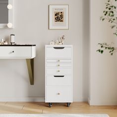 a bathroom with a sink, mirror and white dresser in the corner next to a potted plant