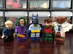 several lego batman minifigures are lined up on a table