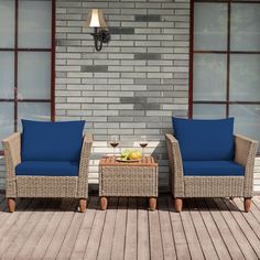 two wicker chairs sitting on top of a wooden floor next to a coffee table