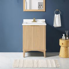 a bathroom with blue walls and a wooden cabinet next to a white rug on the floor