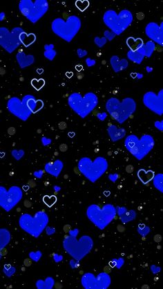 many blue hearts floating in the air on a black background with stars and sparkles