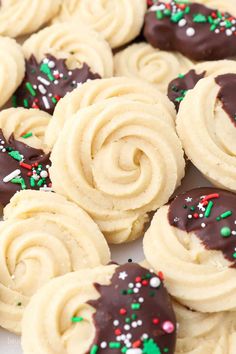 some cookies with chocolate frosting and sprinkles on top are arranged together