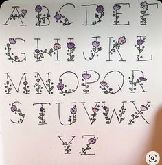 the letters and numbers are decorated with flowers on white paper, which has been drawn in black ink