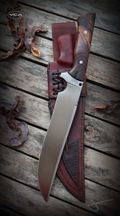 a knife is laying on top of a leather sheath