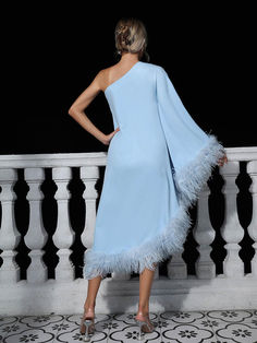 a woman in a light blue dress with feathers on the skirt is looking at something