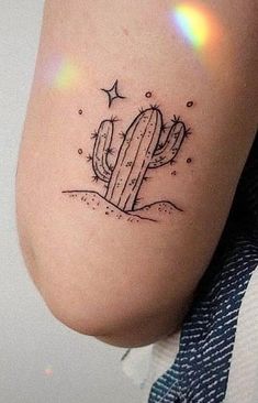 a small cactus tattoo on the thigh